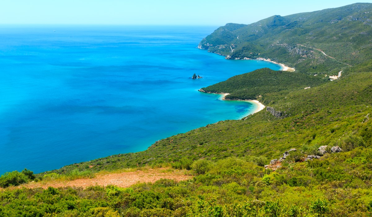Just an hour from Lisbon, hidden in the lush folds of the Arrábida Natural Park, lies an ethereal coastal realm—a blend of jewel‑blue water, pine‑draped mountains, and graceful bottlenose dolphins dancing in the Sado estuary. It's nature and magic, quietly coexisting. This region, protected since 1975 and now under UNESCO Biosphere consideration, is a haven for wildlife and sustainable adventure musement.com +1 arrabidalife.com +1 . Here, the easy beaches and scenic cliffs of Arrábida meet the dolphin‑rich waters off Setúbal and Tróia, making it Portugal’s most enchanting marine escape. Top 5 Highlights of the Experience Dolphin-watching boat tour – Hop on a guided boat with local experts; tours guarantee a 98% chance of spotting playful dolphins in their natural estuary home tripadvisor.com +11 theabroadguide.com +11 arrabida-tours.com +11 musement.com +1 civitatis.com +1 . Visit hidden coves – Many tours include stops at secret coves like Ribeira do Cavalo and Portinho da Arrábida—quiet, photogenic, and often untouched arrabida-tours.com . Explore Arrábida by jeep or hike – Pair your marine adventure with scenic trails in the park, stopping at viewpoints like Bad Roman and Sesimbra castle arrabida-tours.com . Sample local wine – Many full‑day tours include tastings of Moscatel or regional wines at a Setúbal vineyard. Sustainable, small-group ethos – Tours emphasise eco-responsibility: lifejackets, informative guides, and respectful dolphin‑watching protocols. Why It Matters This is one of only three European estuaries where dolphins live year‑round. The experience connects you to nature’s rhythm—silent conversations with waves, wind, whales, and wildlife in a protected paradise . Insider Tip Dolphin-Watching in Arrábida & Sado